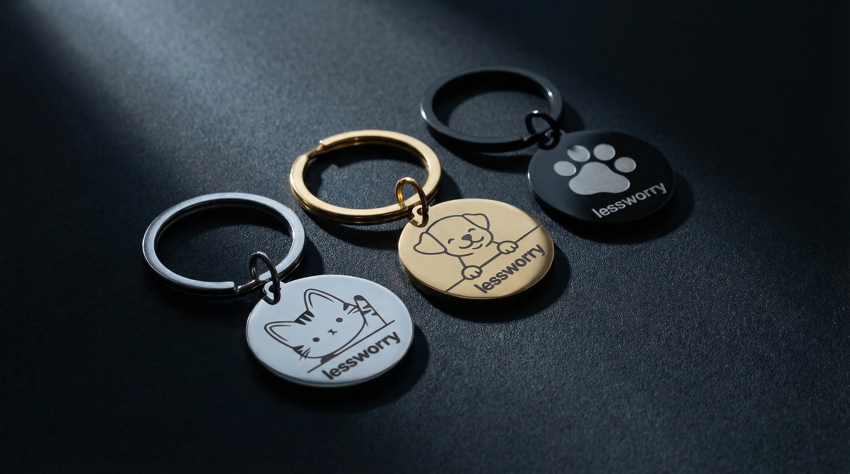 LessWorry metal pet tags in gold, silver, and black finishes on a premium dark surface