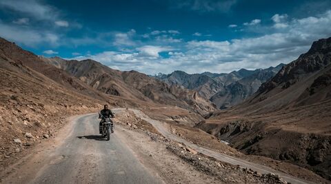Lone rider on a remote Ladakh mountain road